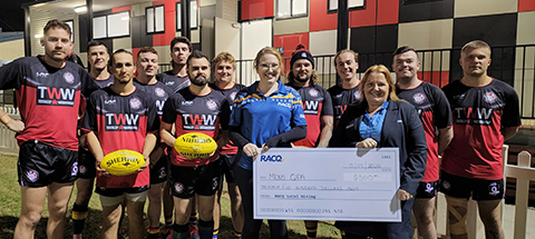 afl team holding up cheque