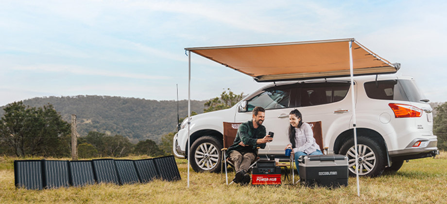 Battery adventure packs couple sitting under four wheel drive