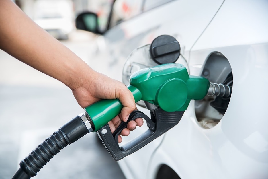 Person filling up car at petrol pump fuel