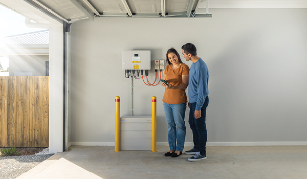 woman and man looking at solar sungrow machine panel