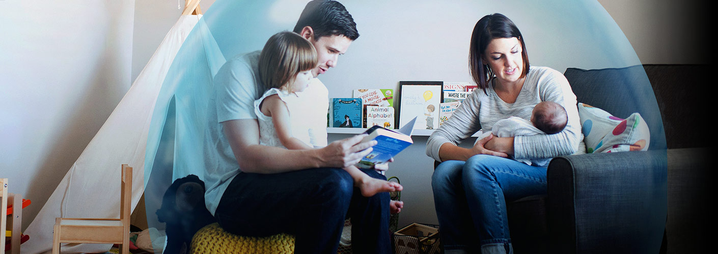 young-family-in-nursery-reading-a-book-1410x500